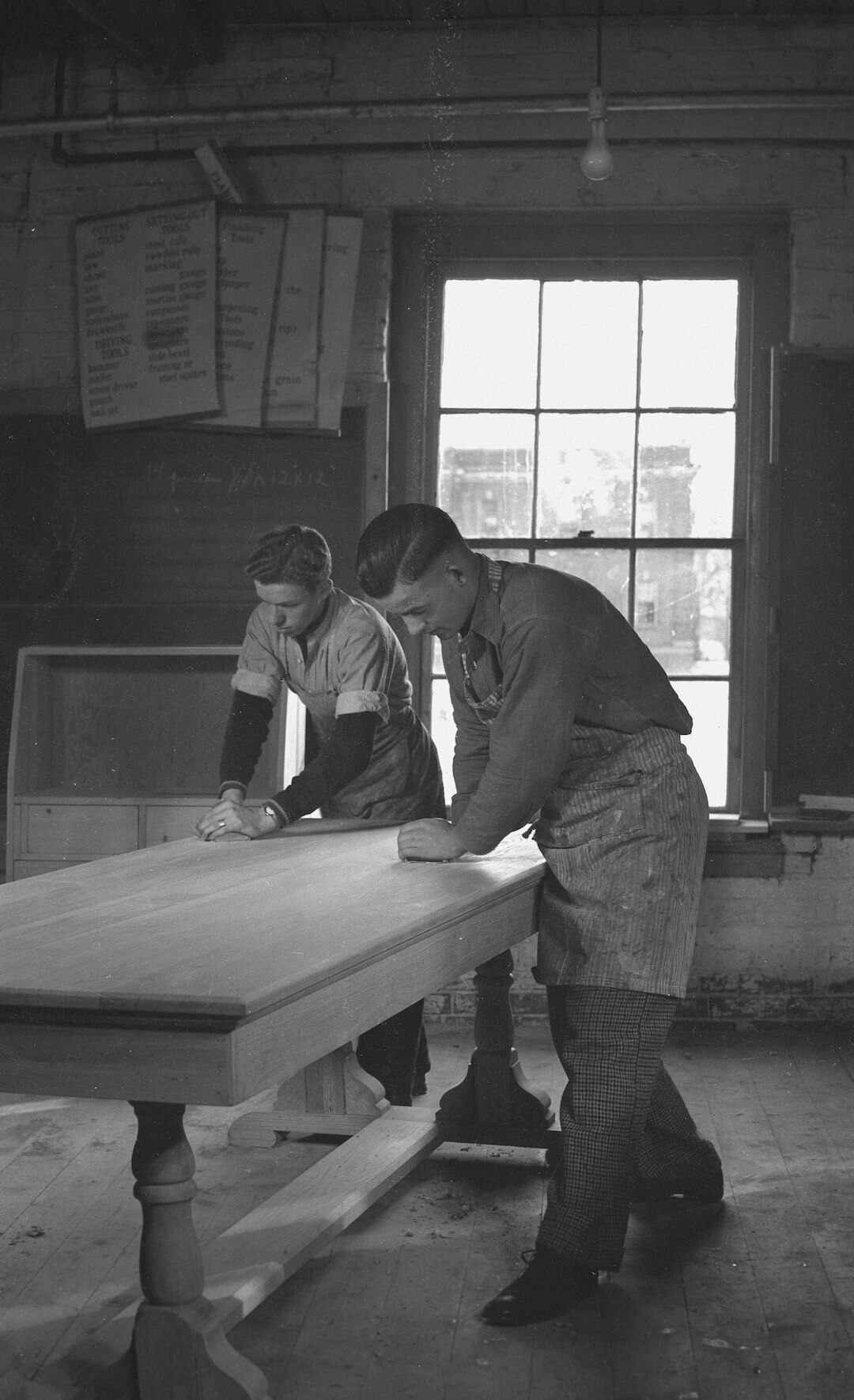 Editorial team reviewing archival photographs at a wooden table