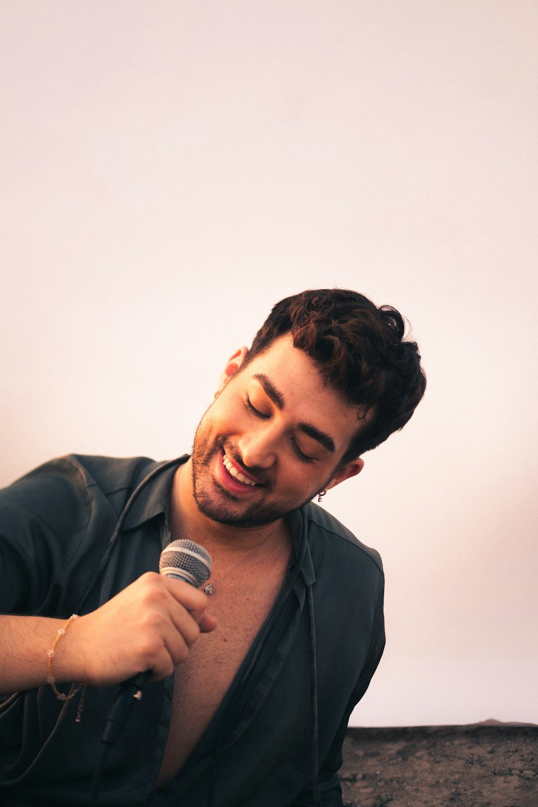 Portrait of an Argentine musician holding a vintage microphone